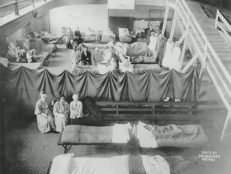 Volunteers tend to the wounded inside of a makeshift hospital set up in a commercial building.