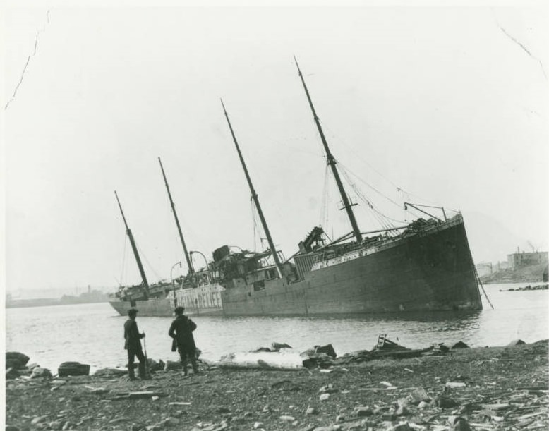 The ruined heap of the SS Imo, one of the ships that caused the explosion, lies lifelessly in the water.