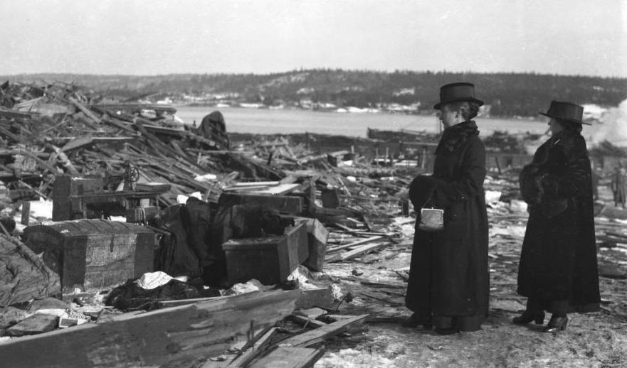 Two women look at the debris, hoping something of the life that went up in flames can still be recovered.