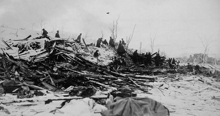 Workers sift through the ruins of peoples' homes.