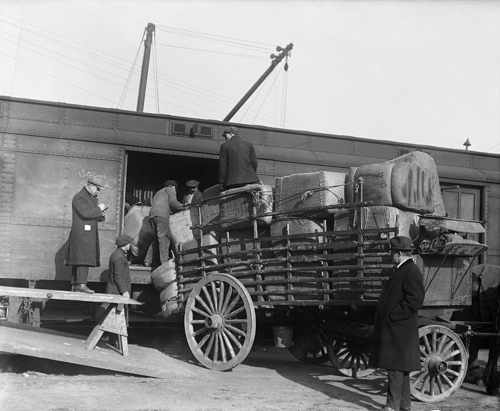 Trucks and vans unloading their supplies at the railroad yards at Hudson River, and transferring them into cars of relief train for Halifax.