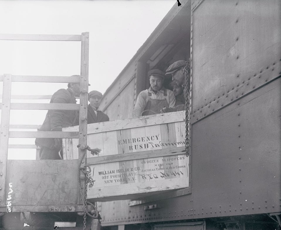 Men loading crates onto Train, 1917.