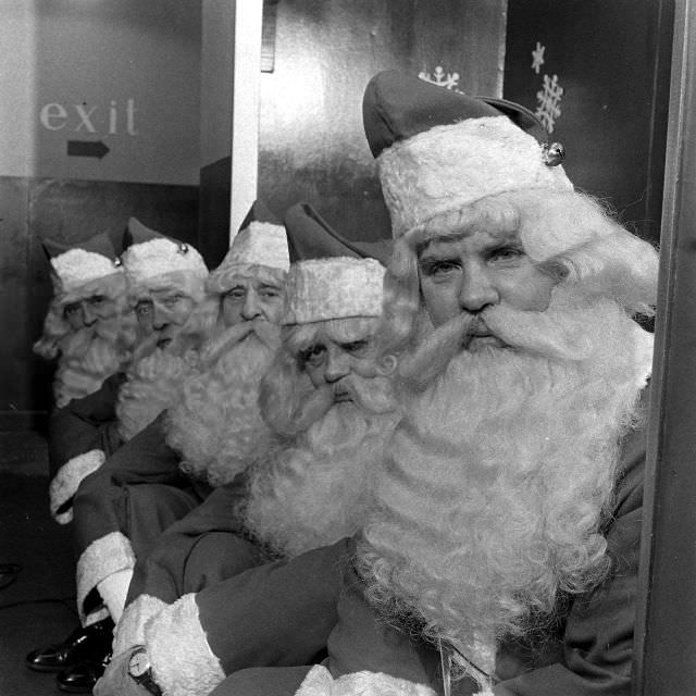 Group of Santa Claus mascots sitting inside the department store.