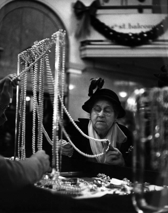 A customer examining a string of pearls.