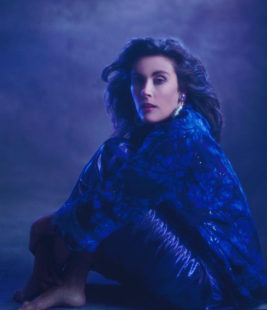 Laura Branigan posing in blue dress, 1985.