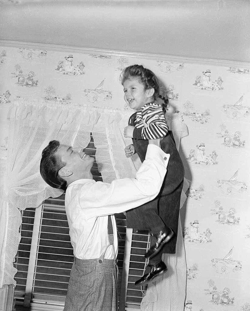 Frank Sinatra tossing Nancy Sinatra, 1950.