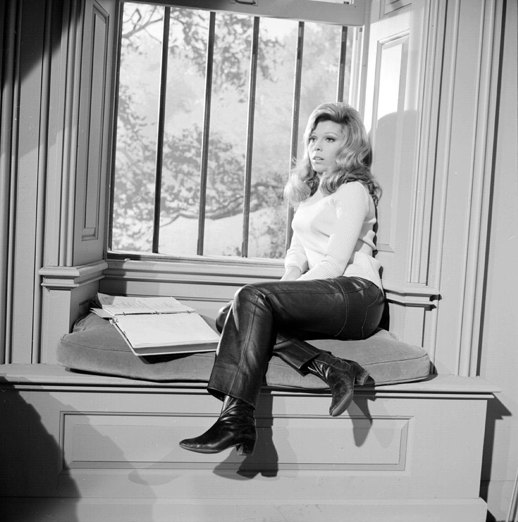 Nancy Sinatra sitting by a window, 1970.