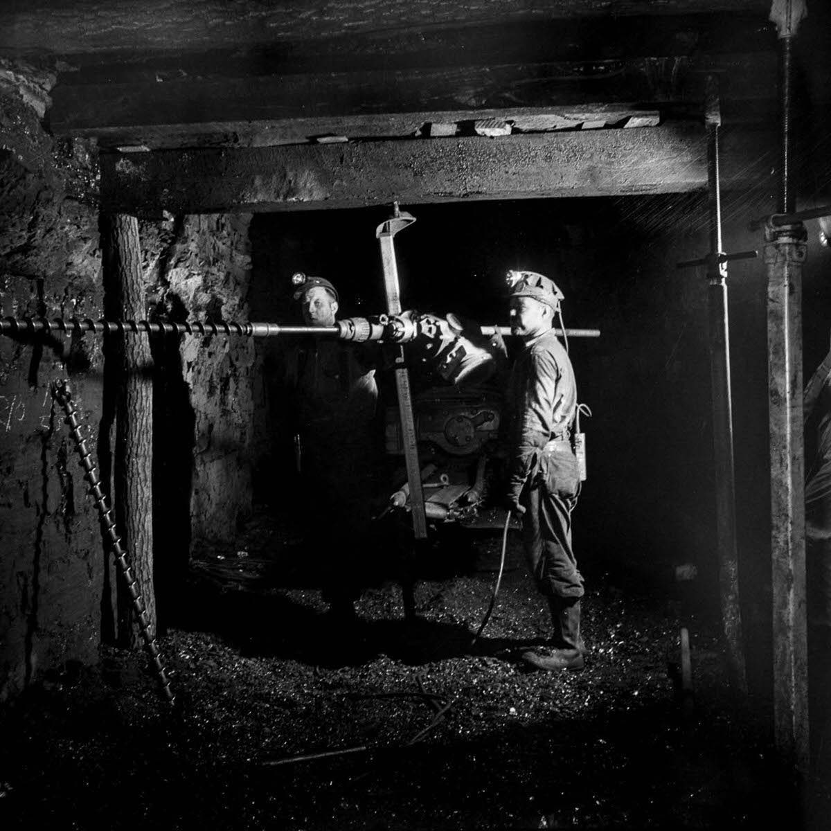 Miners drill a hole for blasting.