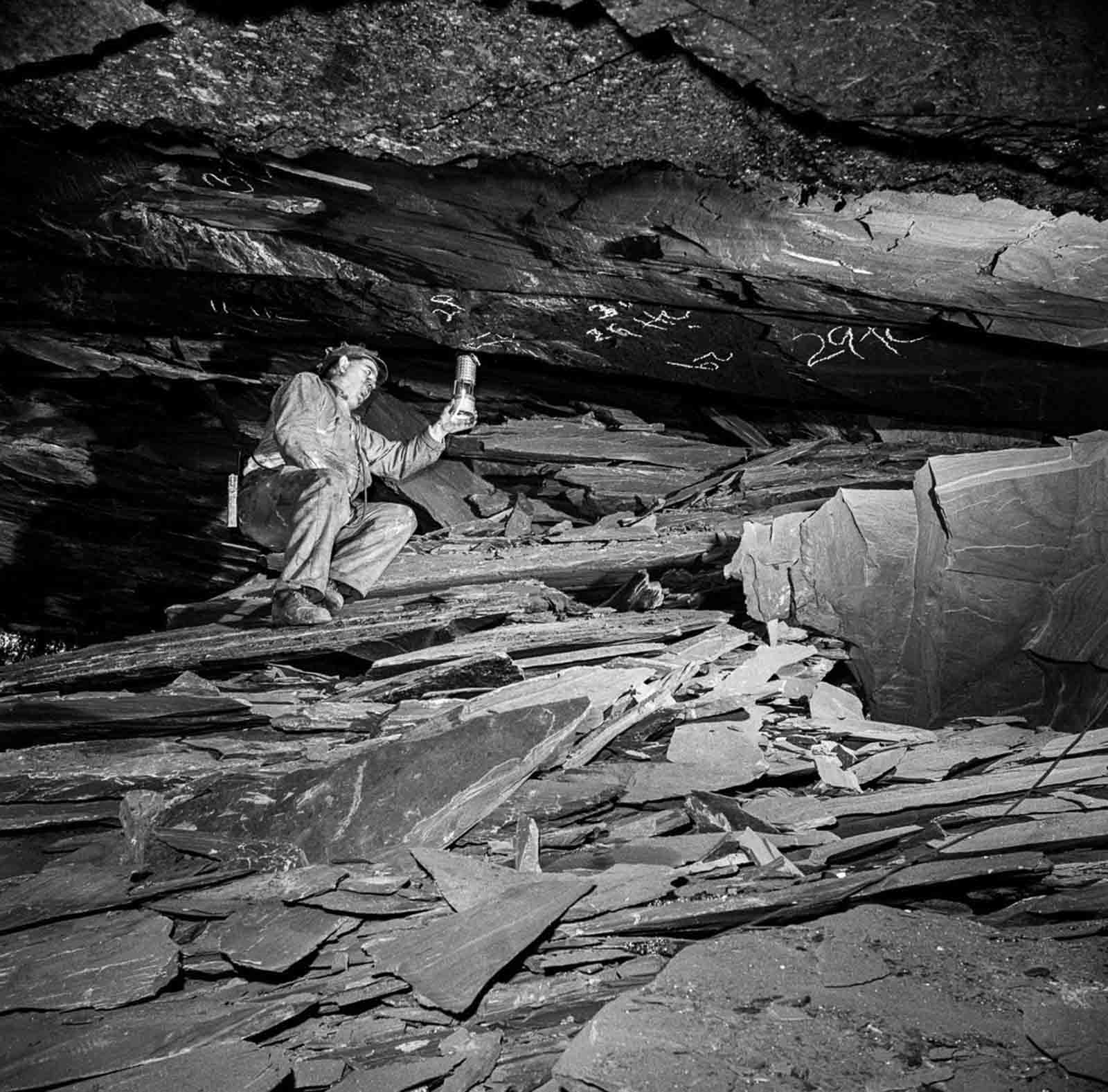 A miner tests for flammable gas using a safety lamp.