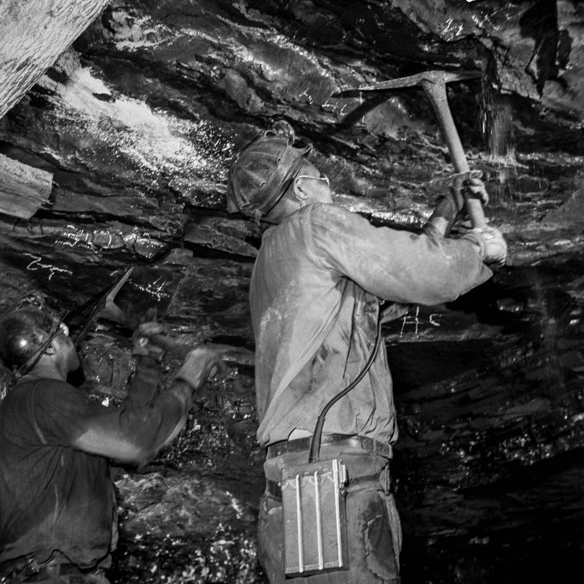 Miners pull down an unstable roof.