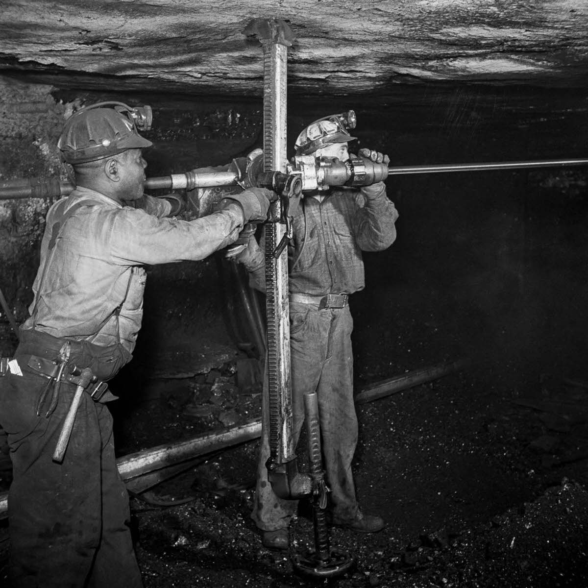 Miners drill a hole for blasting.