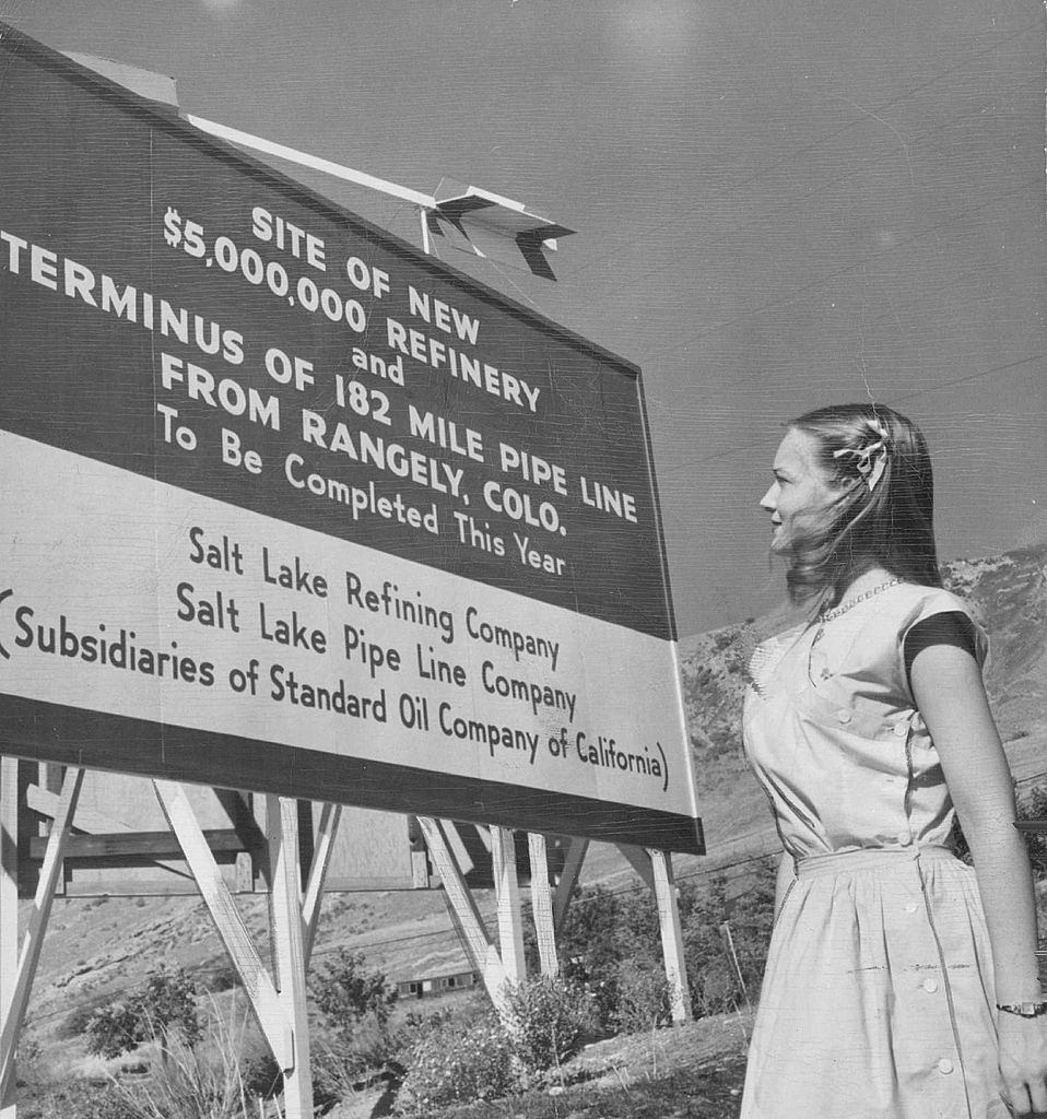 Jerry Stewart of Salt lake city reads a sign announcing the construction of a new multi million dollar refinery which will process crude oil production of Colorado's rich Rangely oil field