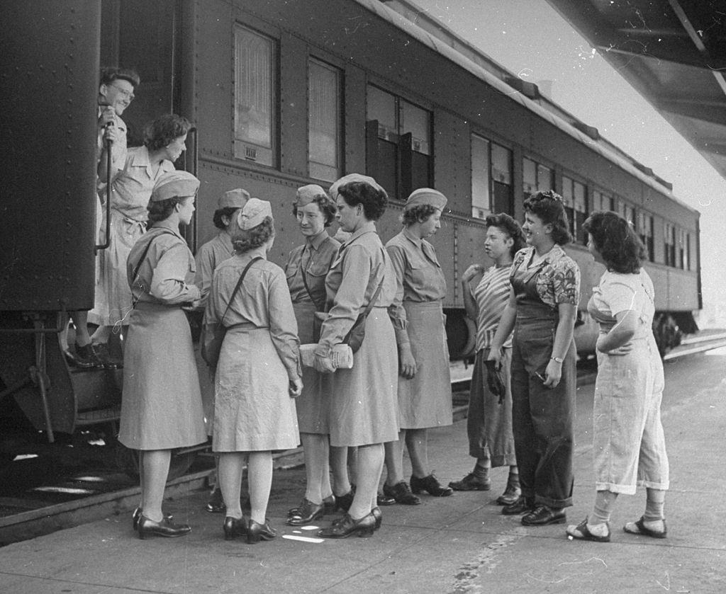 A WAC group preparing to travel on an old tourist Pullman without air conditioning.