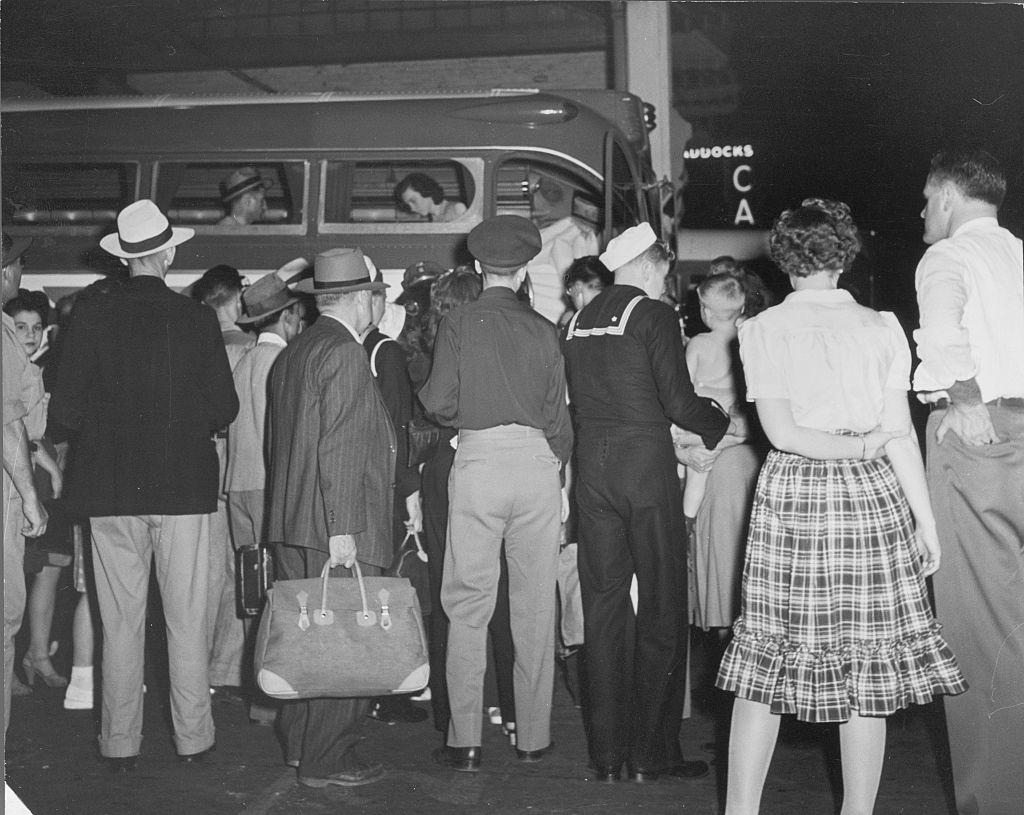 A crowd of people boarding a bus at the station in Salt Lake City, 1945.