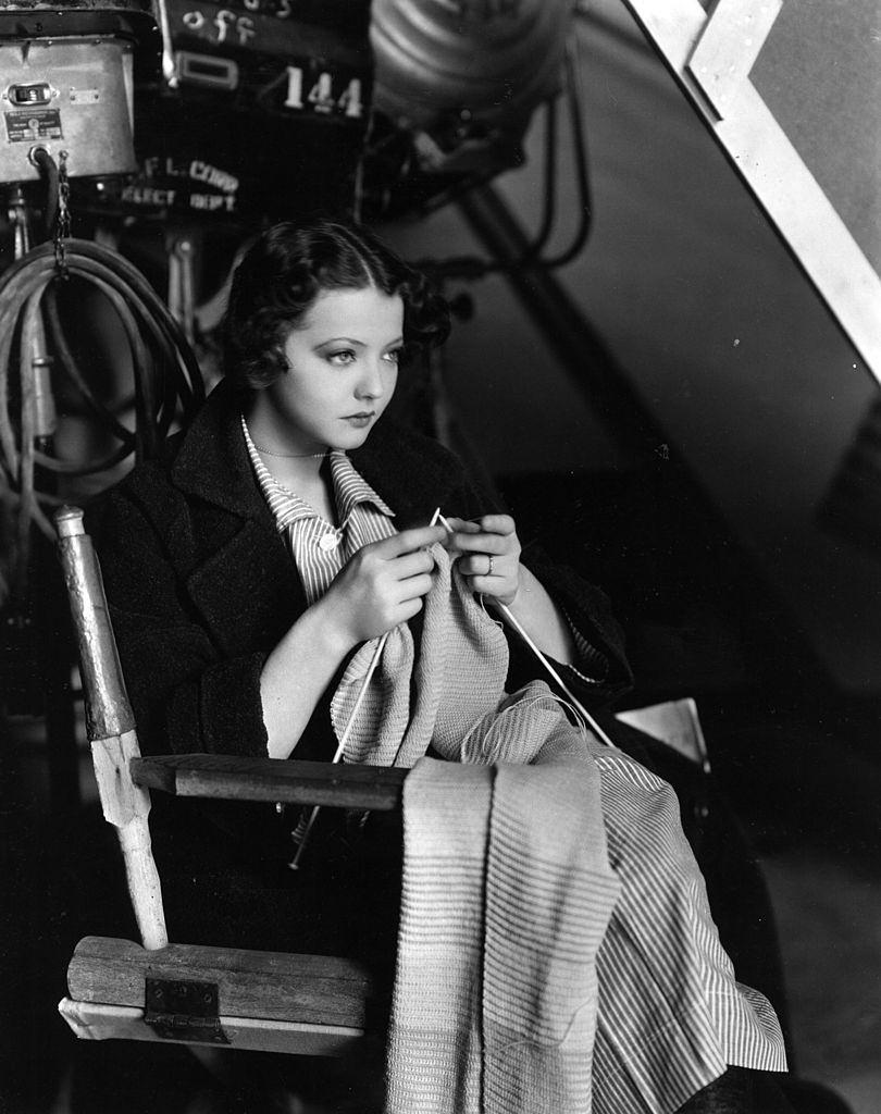 Sylvia Sidney knitting a garment in the movie 'Ladies of the big House', 1931.