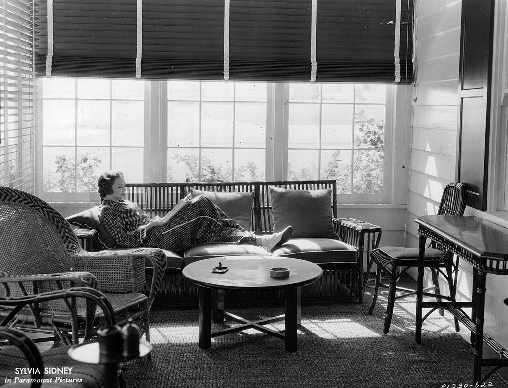 Sylvia Sidney reading in her beach Malibu home, 1935