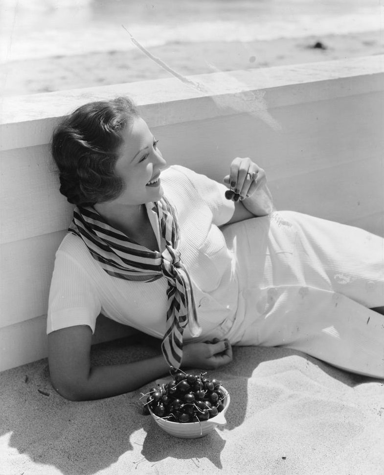 Sylvia Sidney, eating a bowl of fresh cherries, 1935.