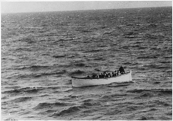 A rescue boat full of survivors makes its way trough the water following the Titanic sinking. April 15, 1912.