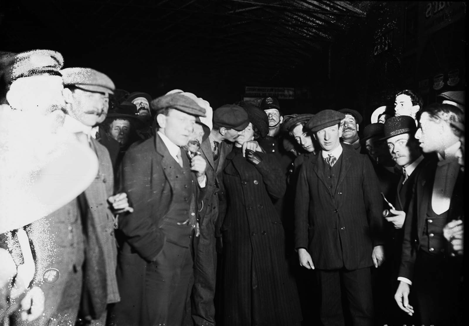 A surviving crew member kisses his wife upon arriving at Plymouth.