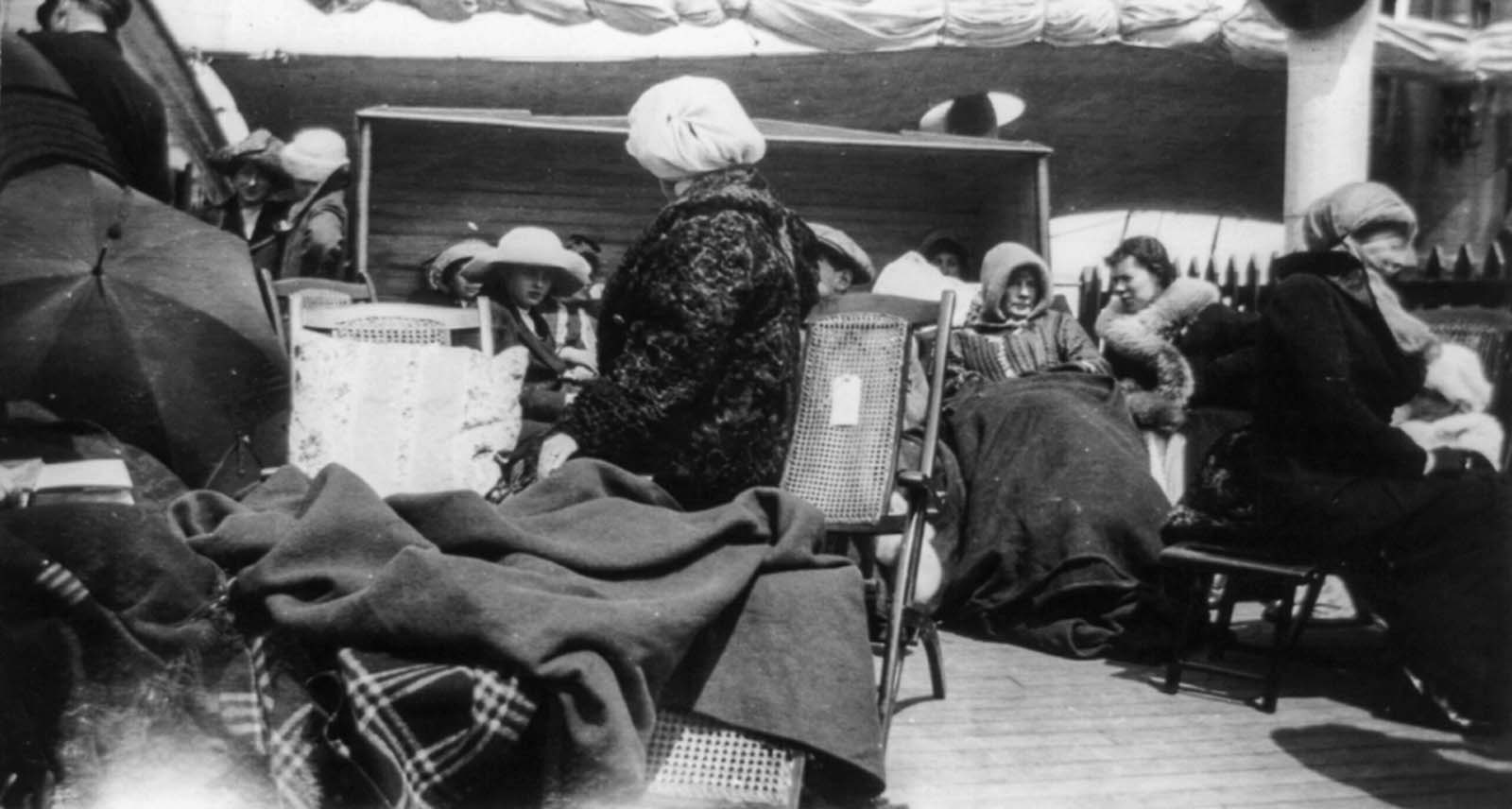 Survivors huddle for warmth on the deck of the Carparthia.