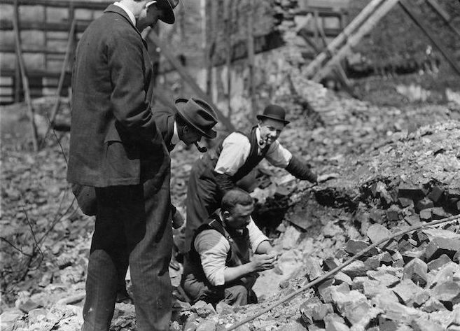 Curio seekers find souvenir in fire ruins.