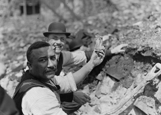 Curio seekers find souvenir in fire ruins.