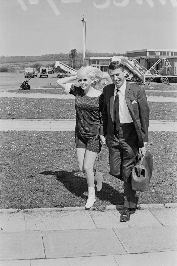 American actress Jayne Mansfield with her friend, club owner and entrepreneur Alan Wells, at Bristol Airport, 1967.