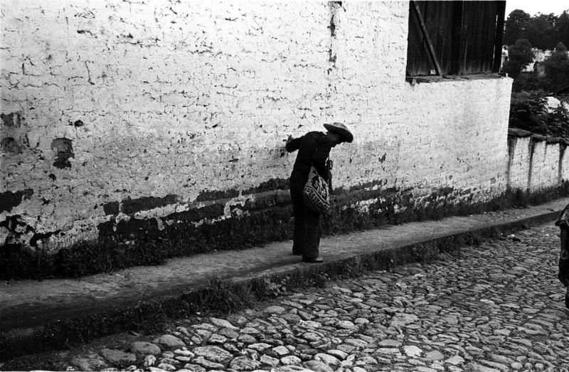 Tipsy man walks home in Chichicastenango, 1982