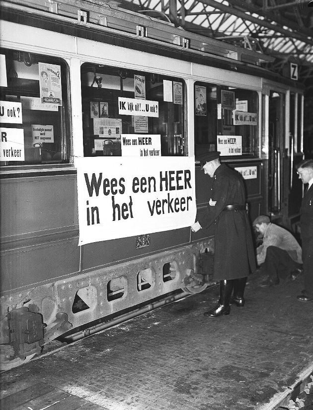 Silver tram with text "'Be a gentleman in traffic' and 'I'm looking forward! .. You too?" in the depot Tollensstraat. Amsterdam, December 9, 1948