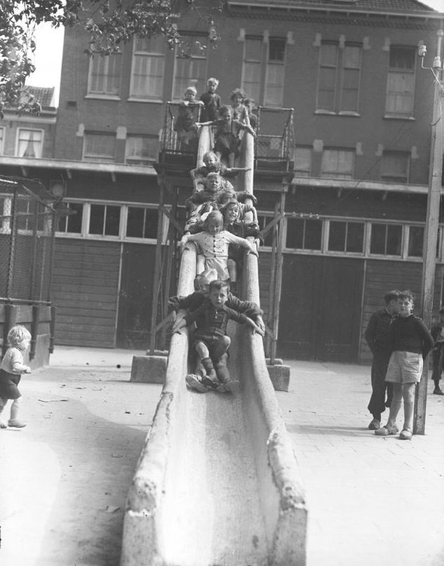 Children on a (hard granite) slide. Amsterdam, 1946