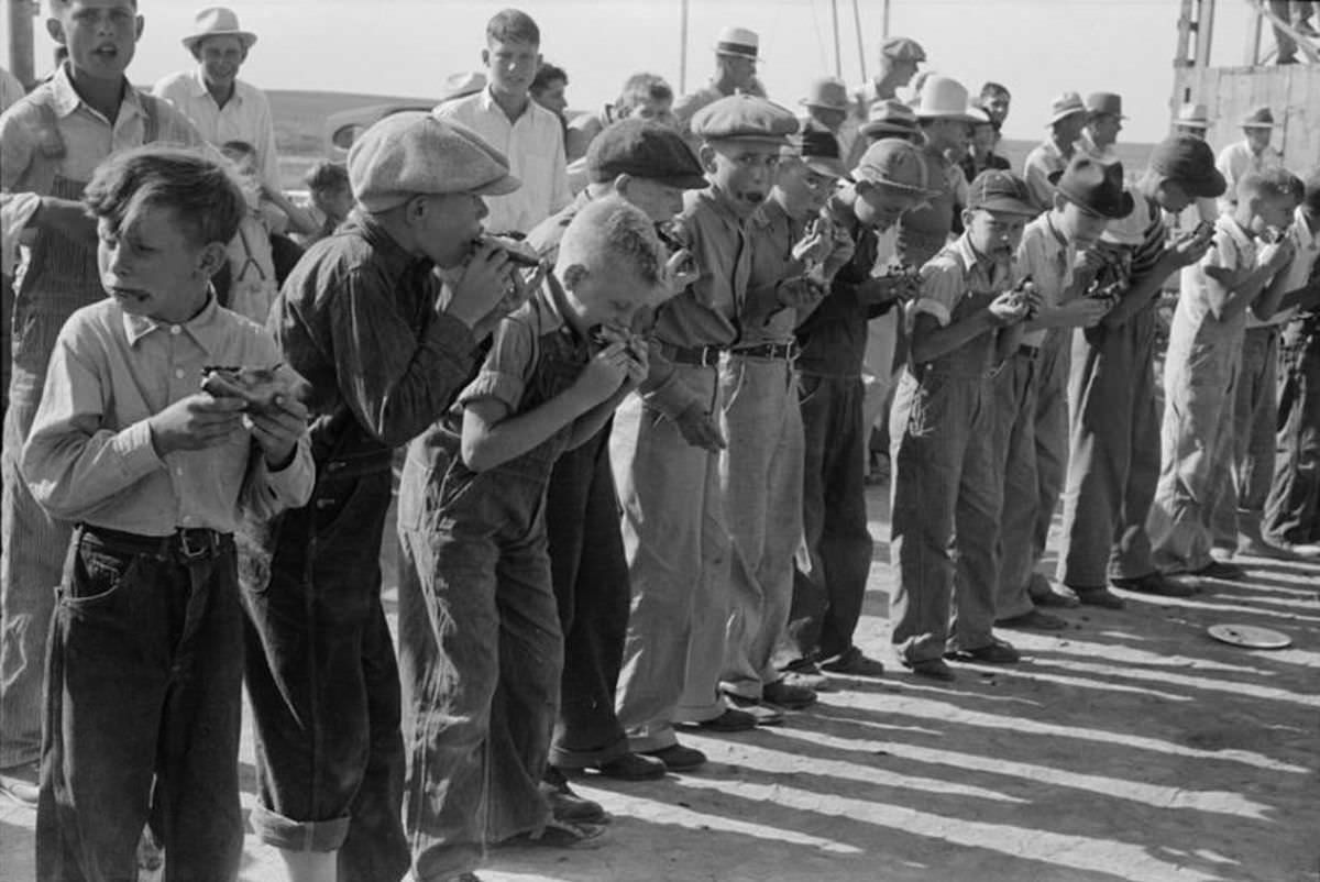 A pie eating contest, at the 4-H Club fair, Cimarron, Kansas, 1939.