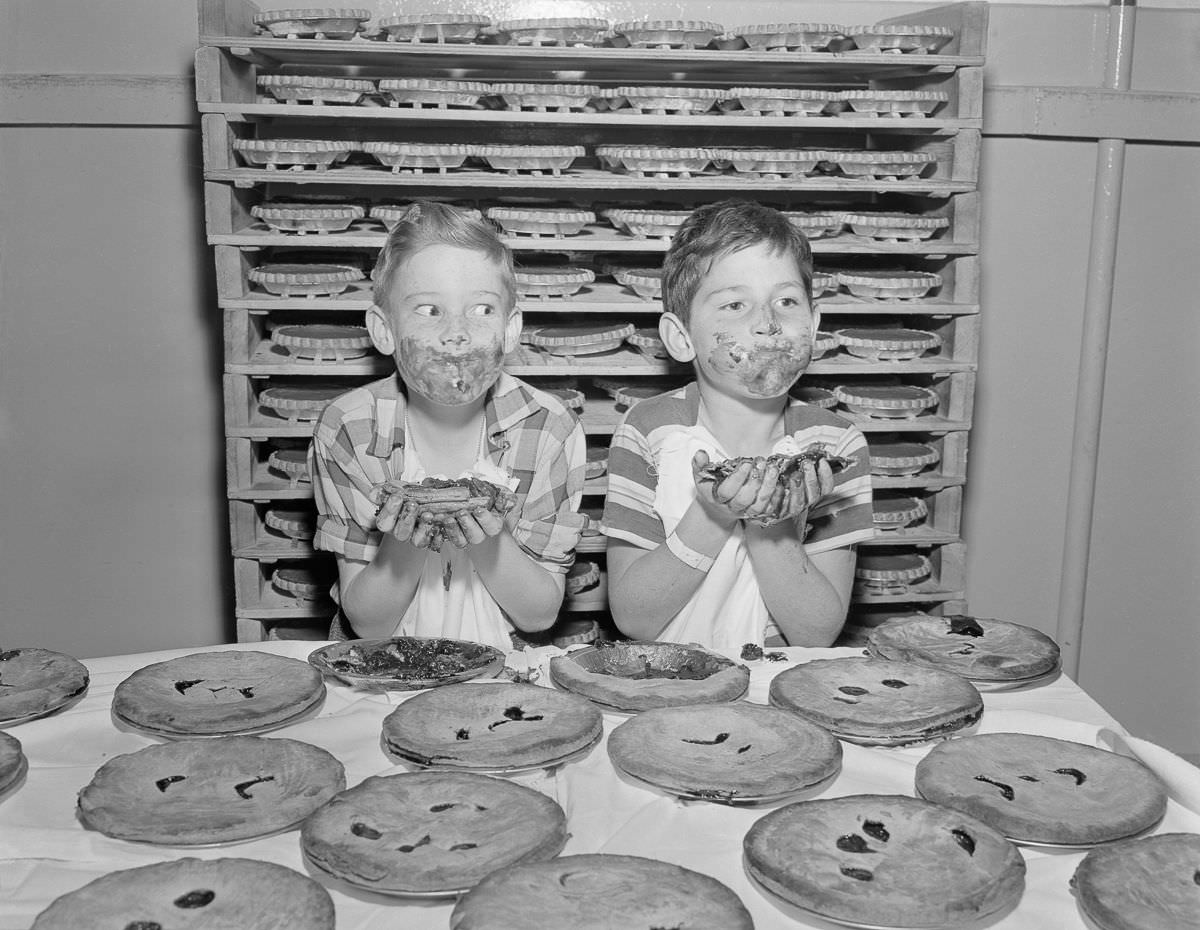 Boys practice for a pie-eating contest at the Los Angeles Food Show, 1950.