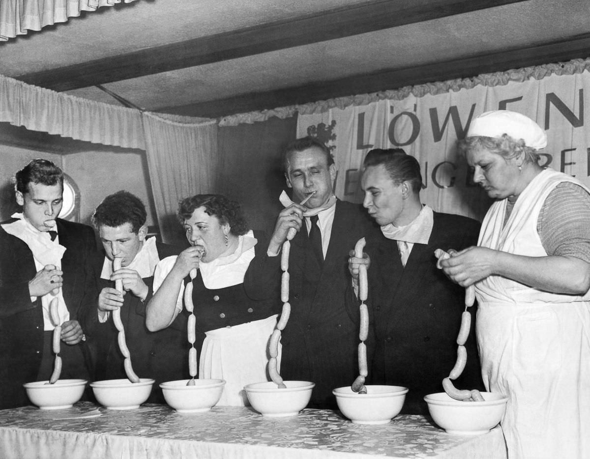 A sausage-eating contest in Munich, Germany, 1952. The winner (second from left) wolfed down 15 sausages in one minute and 45 seconds.