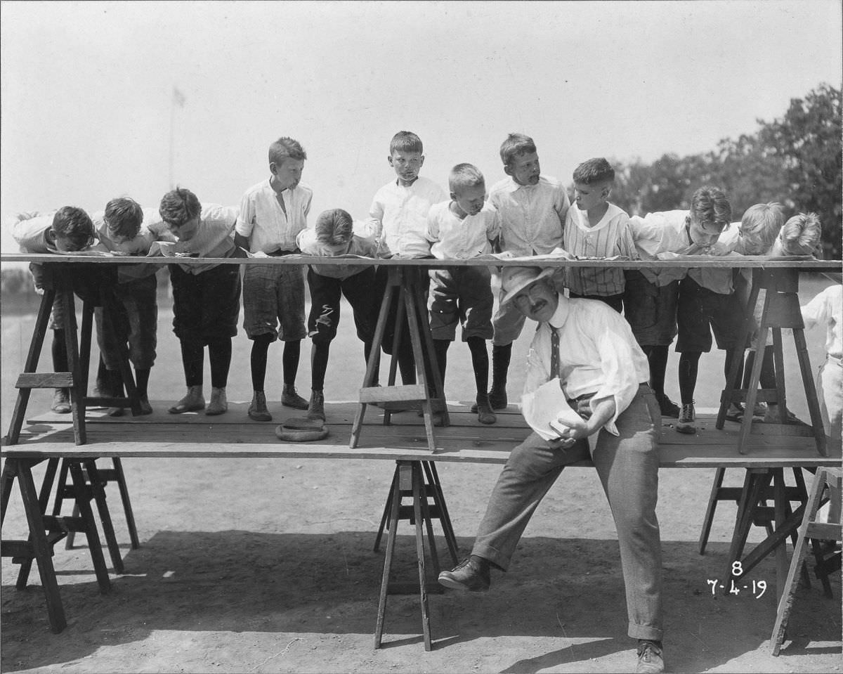 Juniors compete against each other on an Independence Day pie eating contest, July 4, 1919.