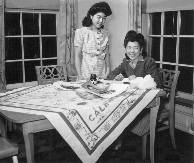 Miss Julie Sugimoto (l) and her sister June (r), work in the home of the Burchette family in Peoria, Illinois.