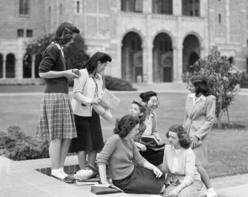 Michiko Kataoka, a freshman, and Meriko Hoshiyama, a junior, both from Manzanar, with fellow students on the University of California campus at Los Angeles, 1945.