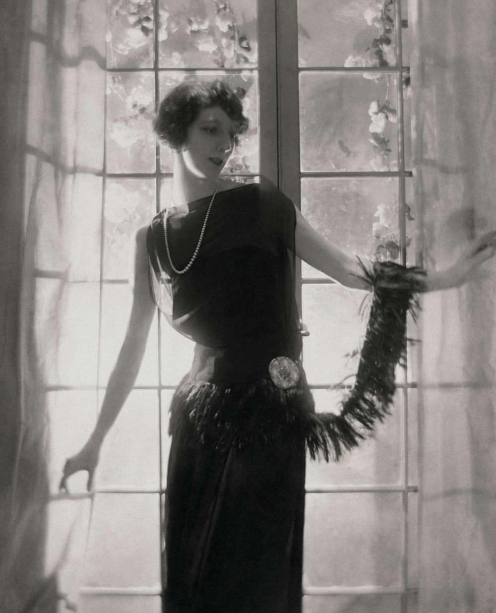 This Jean Patou dress, dating back to 1921, made out of georgette crepe and featuring a fringed waist, is modelled by the dancer Madame Lubovska.