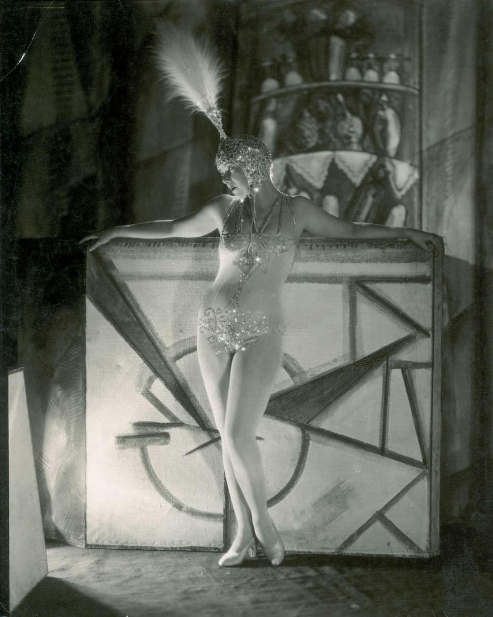 French actress Andrée Spinelly can be seen in 1927 performing in Paris in a sparkly costume and headdress.