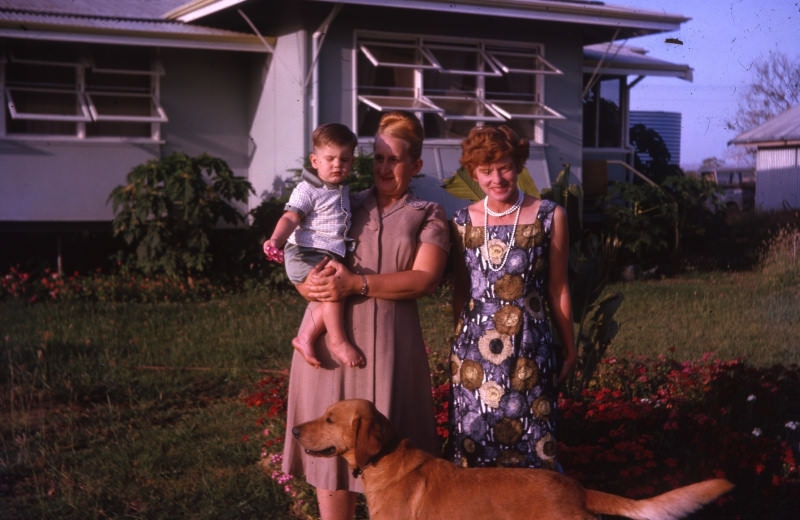 Family and a dog in front of their house, 1963