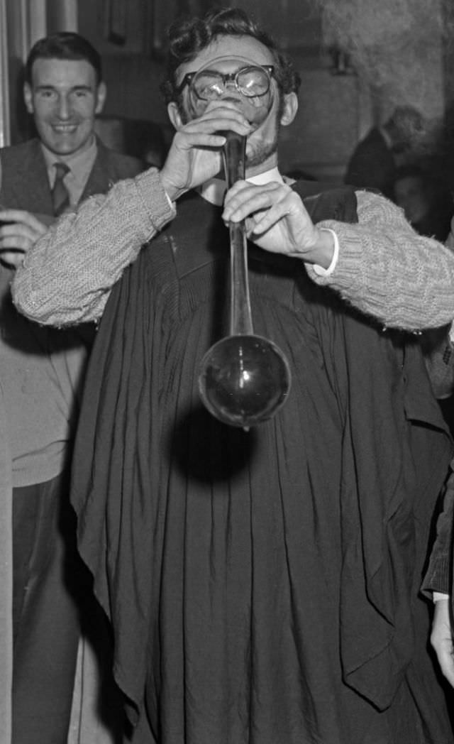 A student sinking a yard of ale at a Cambridge pub.
