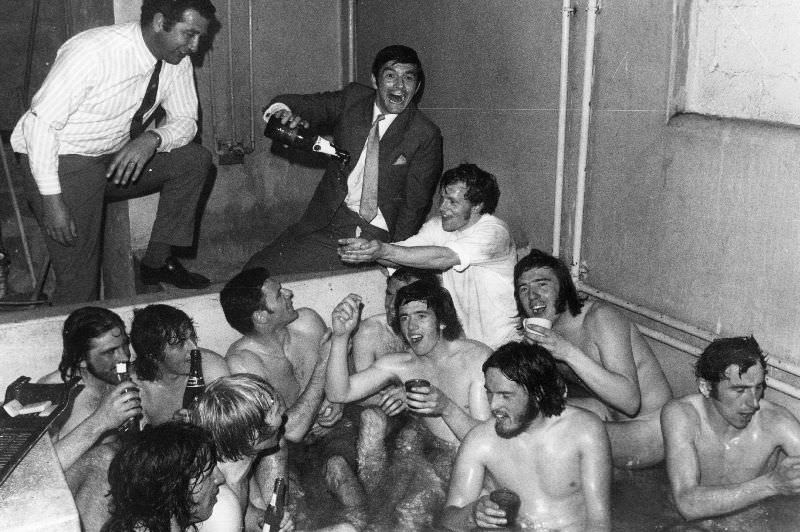 The Birmingham City team celebrating a win with champagne in the bath.