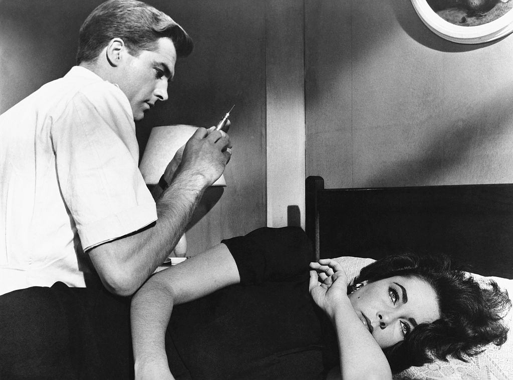 Elizabeth Taylor is shown about to receive a sedative from a man with a syringe in the movie "Suddenly Last Summer," 1959.