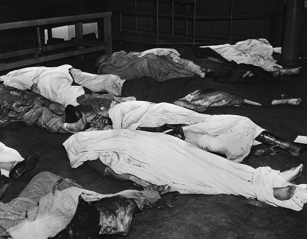 Shoruded bodies of dead victims of the Winecoff Hotel fire lie on the floor in the morgue at Grady Hospital.