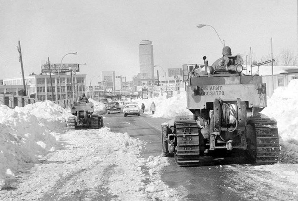 Two members of the U.S. Army 27th Engineers from Fort Bragg, N.C. move their bulldozers slowly toward downtown Boston as the city began to remove the record snowfall from the streets, Feb. 11, 1978.