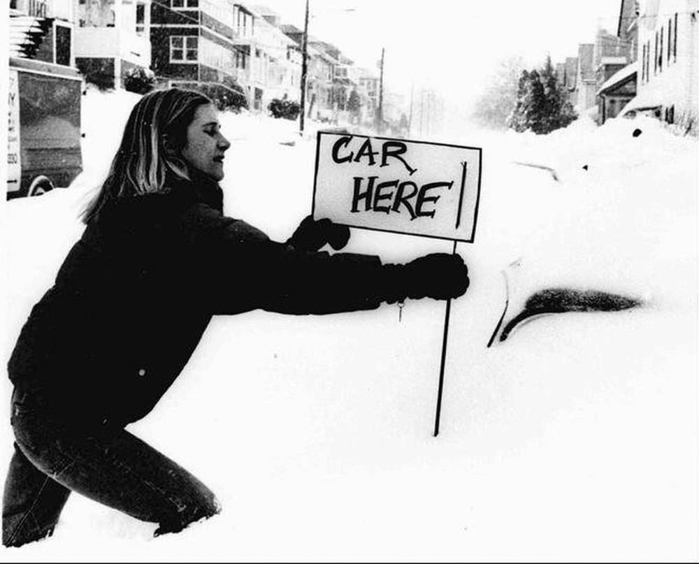 Bonnie Alexandre, of Boston’s Brighton district, attaches a sign to the antenna of her car in Boston