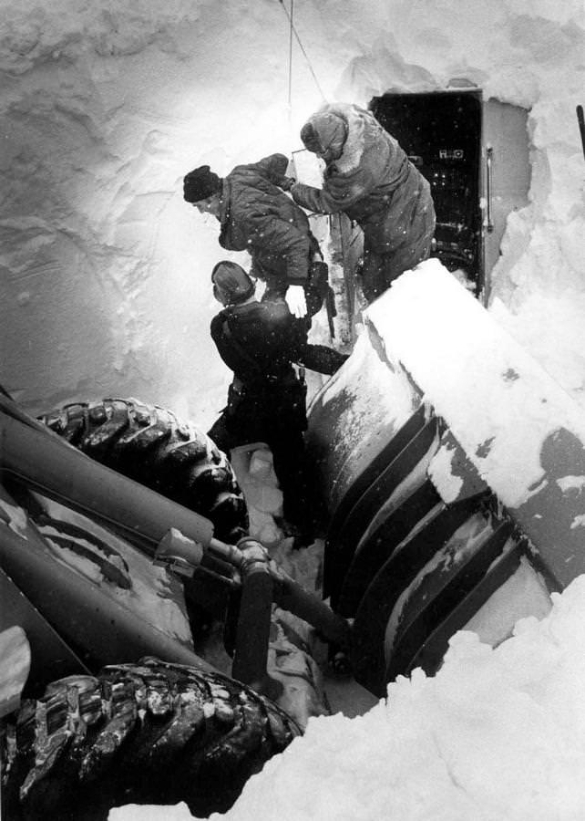 Truck driver James Truly is helped from the cab of his rig after spending most of five days buried in the truck beneath a huge snowdrift in Mansfield, Ohio, Jan. 31, 1978.