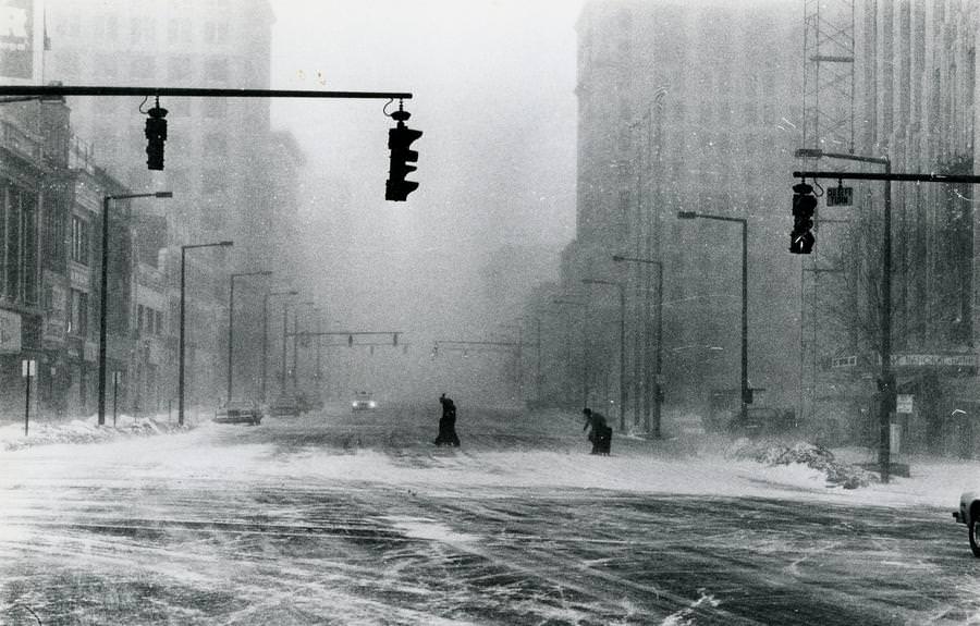 Pedestrians struggle to cross an Akron road during the blizzard on Jan. 26, 1978.