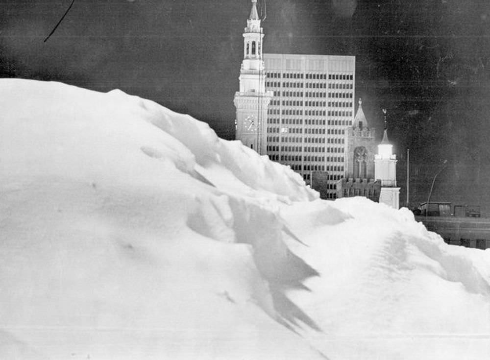 A pile of snow in a parking lot frames a view of downtown Springfield during the Blizzard of 1978.