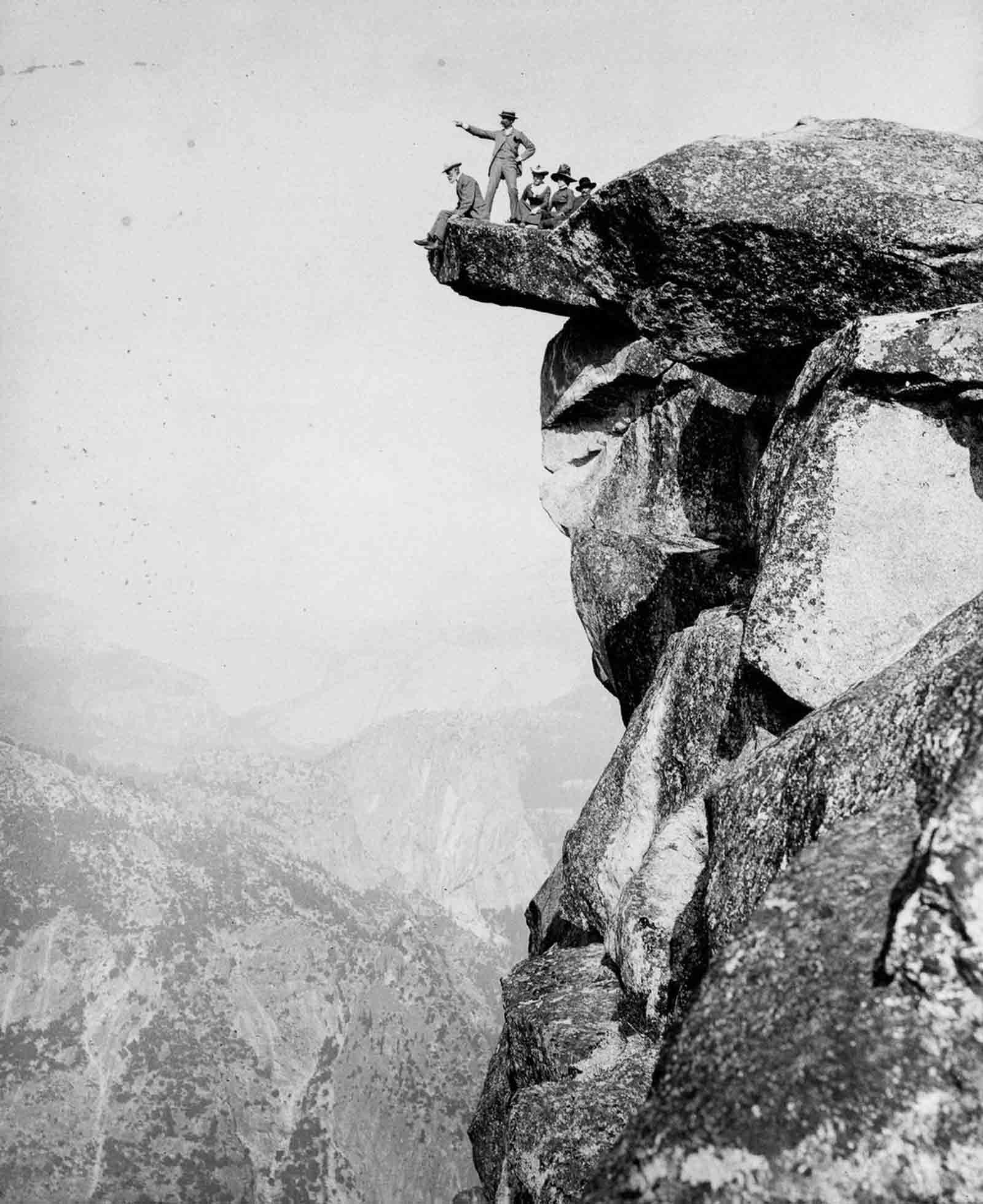 Tourists pose on Glacier Point above the Yosemite Valley, 1887.