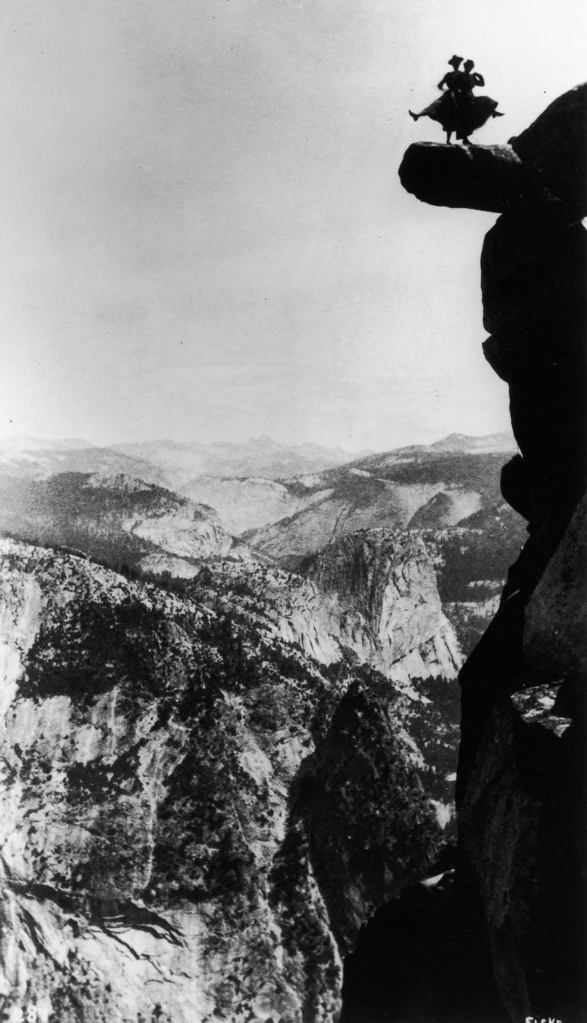 Kitty Tatch and friend dance on the overhanging rock at Glacier Point in Yosemite.